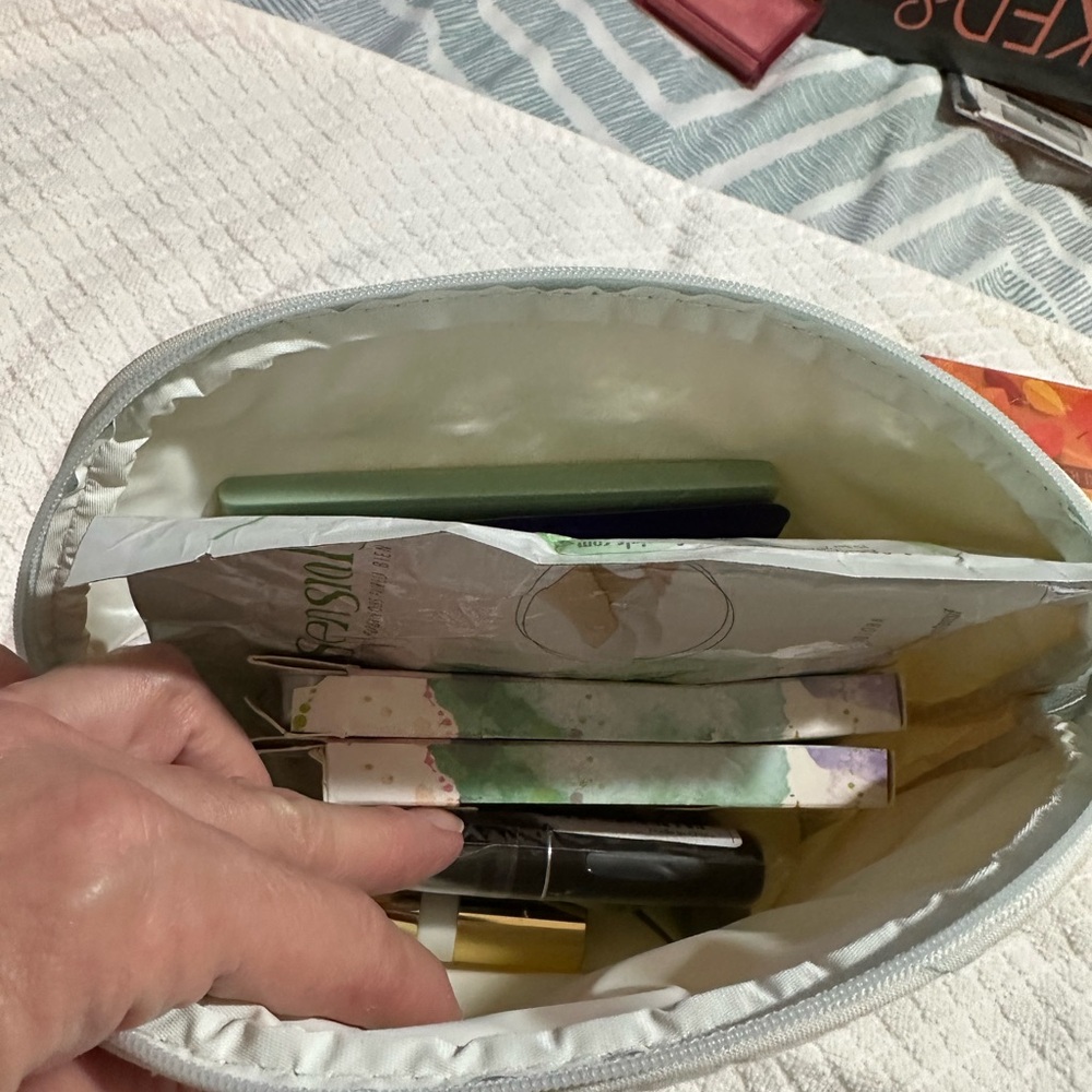 White Cosmetic Bag with Assorted Makeup